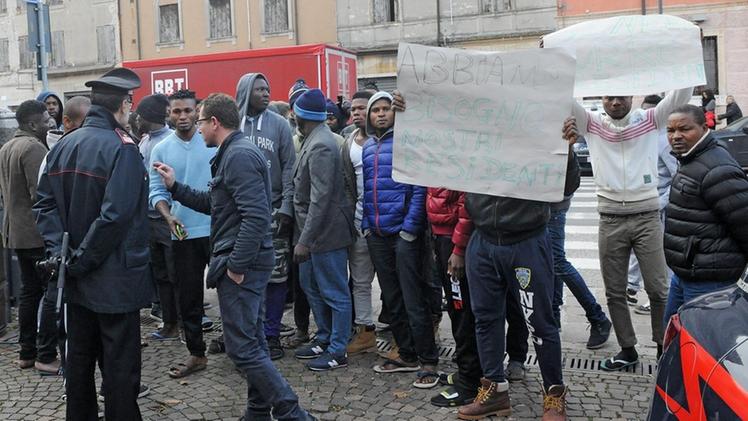 I profughi mentre manifestano davanti al municipio controllati dai carabinieri DIENNEFOTO