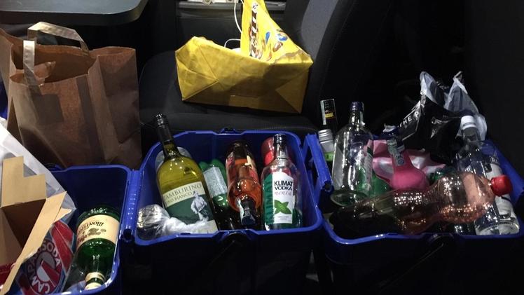 Un agente della polizia municiplae controlla le bottiglie sequestrate a CustozaGli alcolici sequestrati a Custoza posti sabato sera sul mezzo della polizia municipale