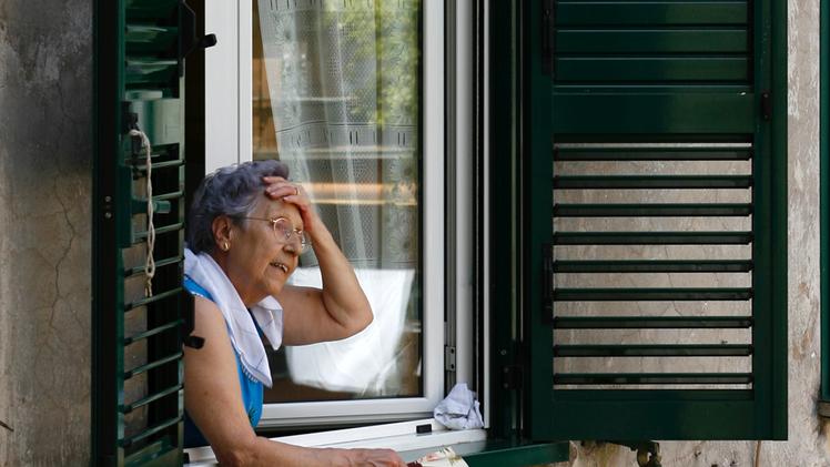 Un'anziana affacciata alla finestra